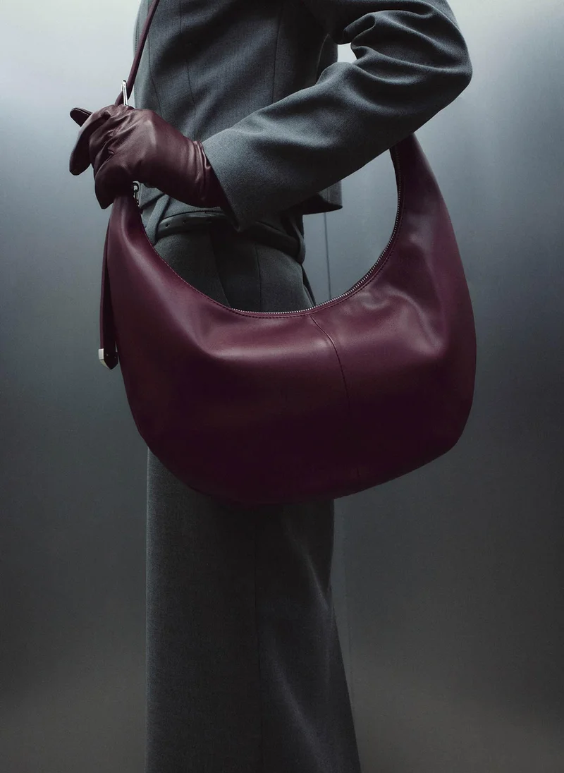 Semi-circular bag with long shoulder strap