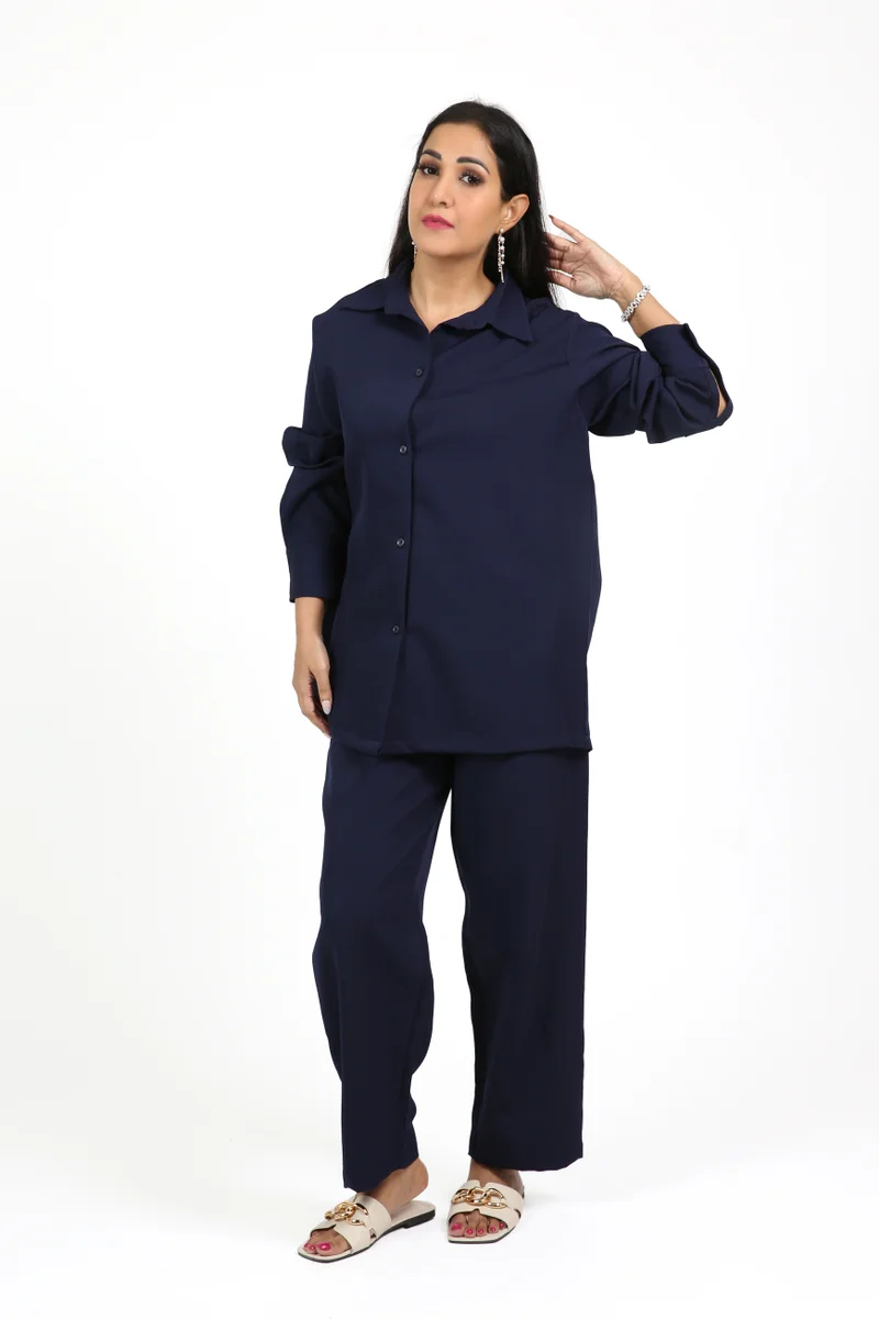 A sleek Black Crepe Overlap Abaya designed with signature loop accents along the front and sleeves