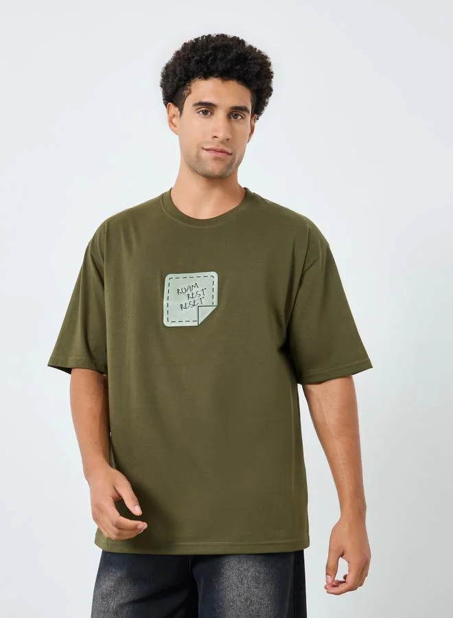 Styli Men Olive Graphic Print Oversized T-Shirt