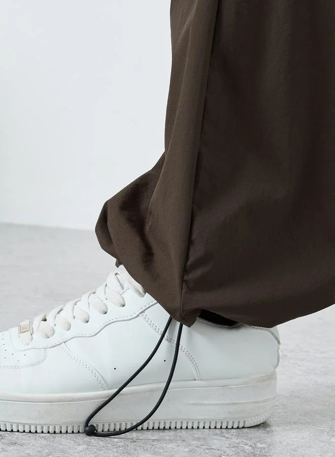 Styli brown Women Brown Plain Oversized Parachute Pants with Utility Pockets for Men | Best Price UAE