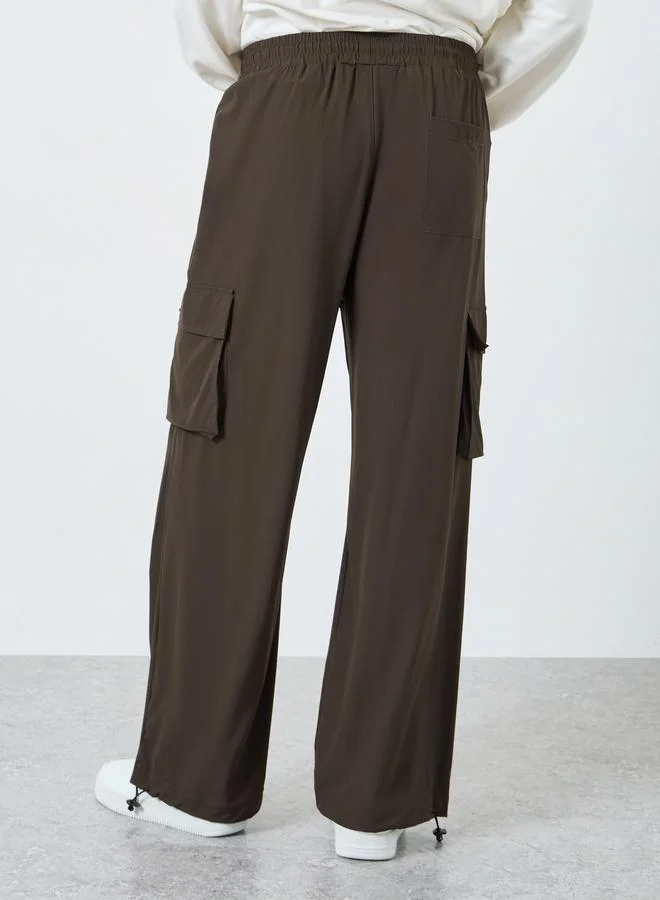 Styli brown Women Brown Plain Oversized Parachute Pants with Utility Pockets for Men | Best Price UAE