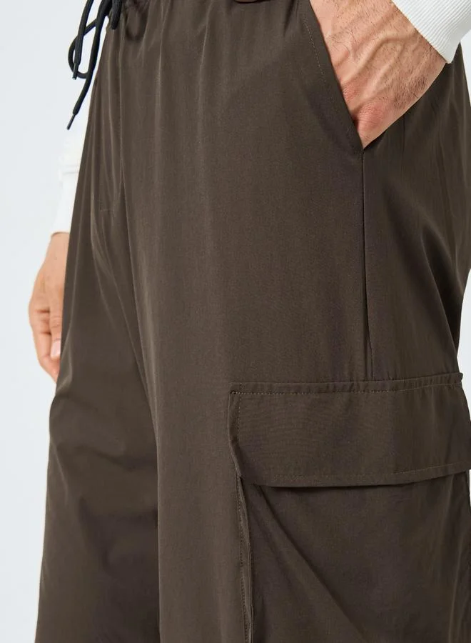 Styli brown Women Brown Plain Oversized Parachute Pants with Utility Pockets for Men | Best Price UAE