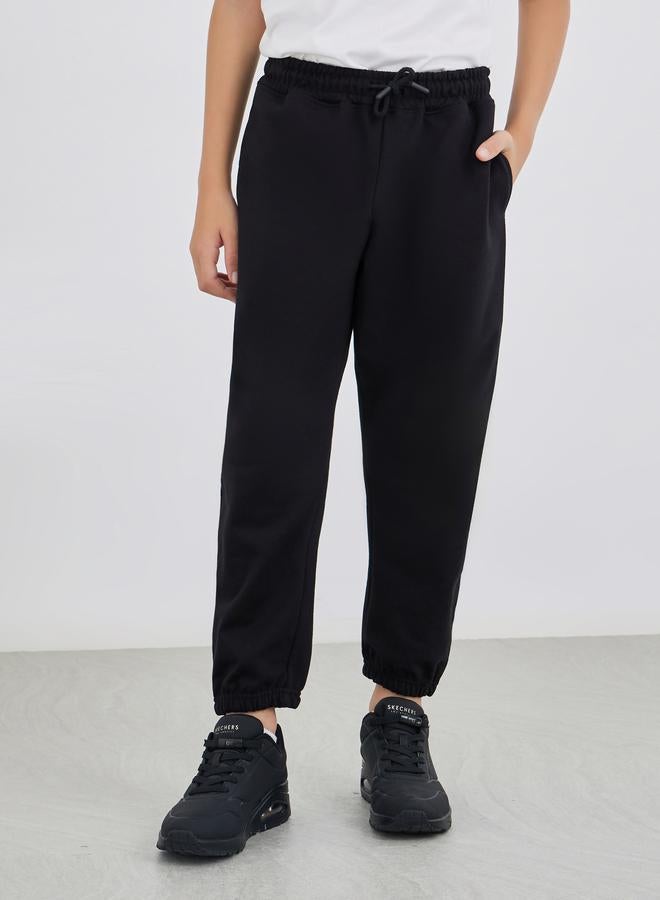 Styli Black Solid Cuffed Joggers With Slip Pockets - Image 1