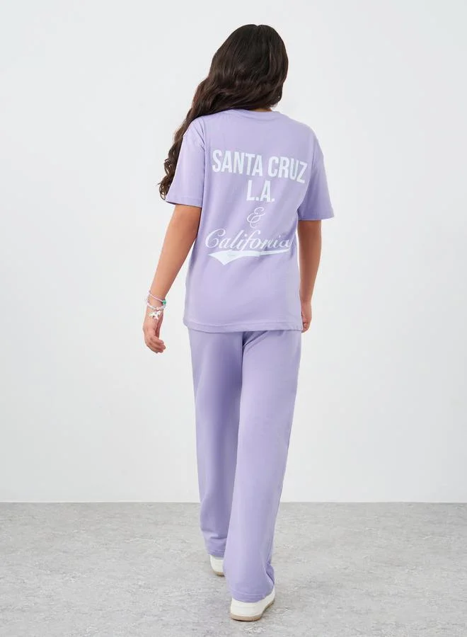 Styli Styli Girls Text Print Oversized T-Shirt and Wide Leg Joggers Set