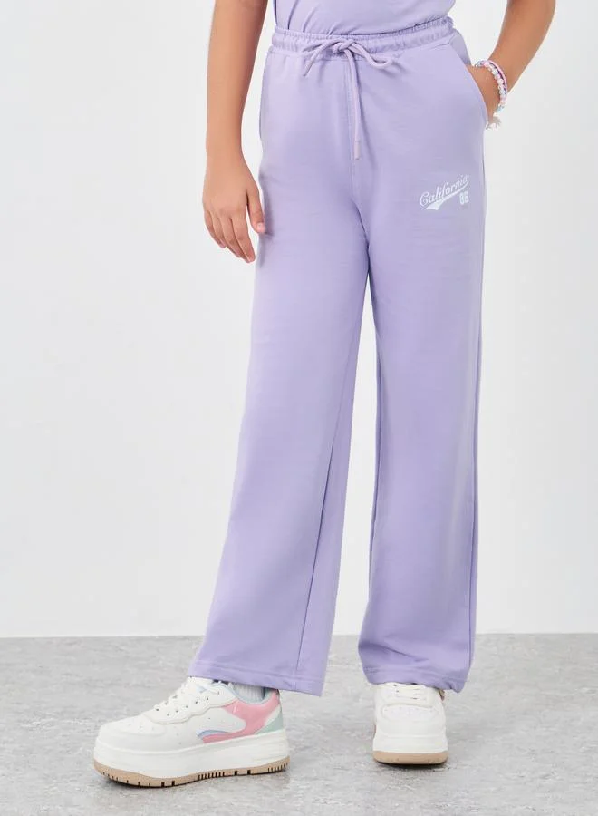 Styli Styli Girls Text Print Oversized T-Shirt and Wide Leg Joggers Set