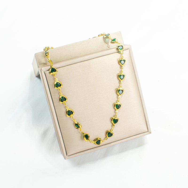 سلسلة أستانليس ستيل ذهبي شكل قلوب مرصعة بفصوص الزيركون الخضراء