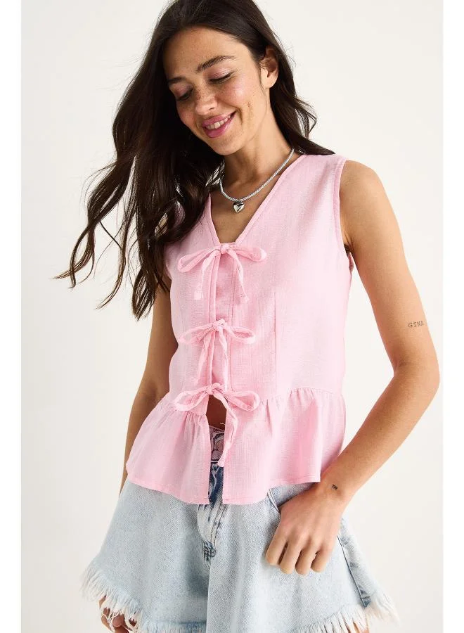 Ginger Bow Tie Up Detail Peplum Top