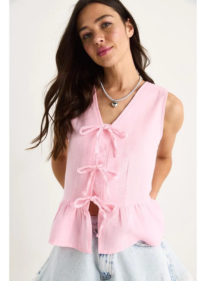 Ginger Bow Tie Up Detail Peplum Top