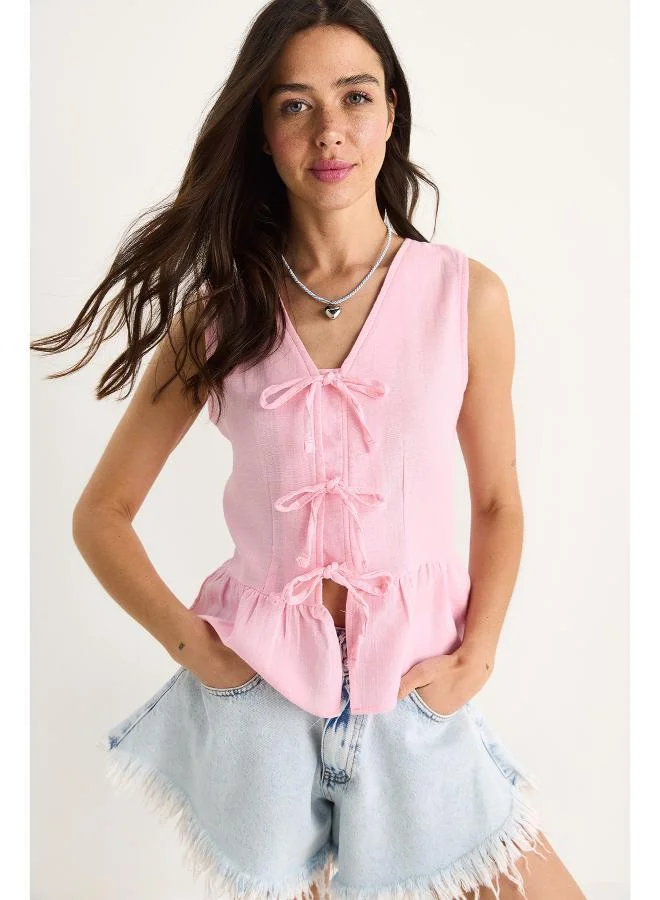 Ginger Bow Tie Up Detail Peplum Top