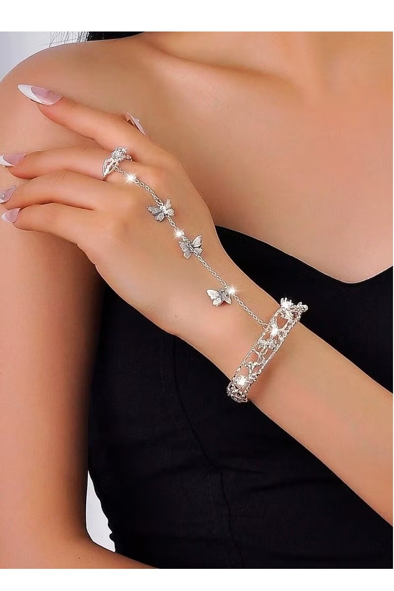 Women's accessory featuring a finger ring connected to a bracelet with a silver chain, adorned with cute butterfly charms. Perfect for weddings, engagement parties, Eid, and all special occasions. - Image 1