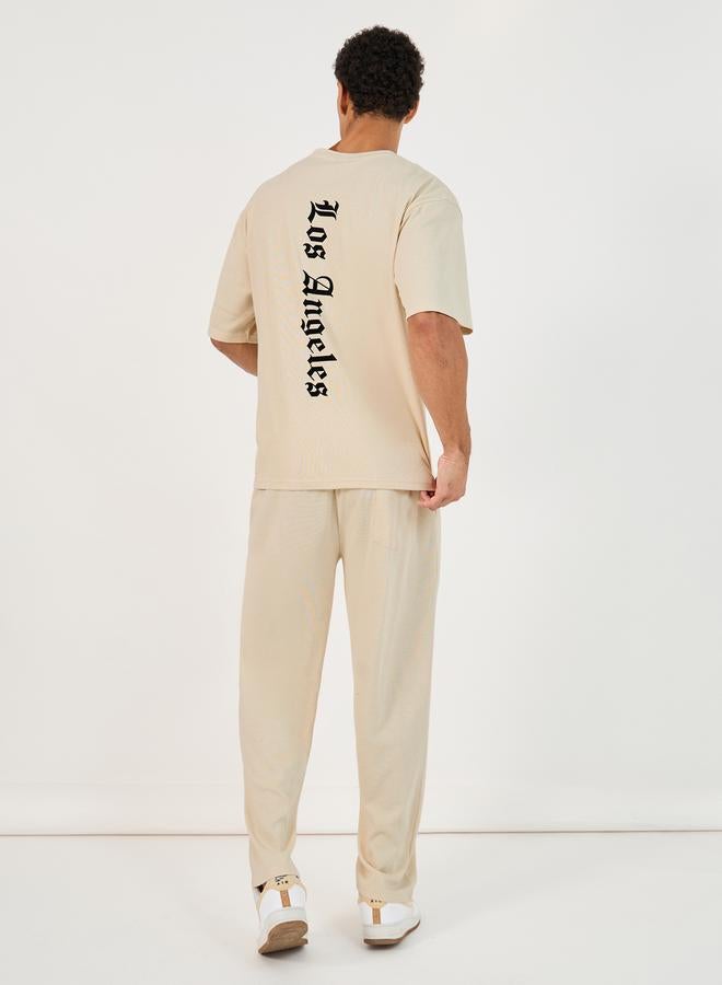 Styli Back Print Oversized T-Shirt & Open Hem Interlock Joggers Co-Ords  - Image 1