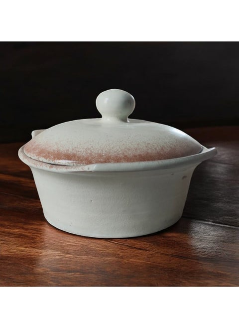 A pottery and porcelain pot with a lid that can withstand direct and indirect heat, from a flame or inside the oven.