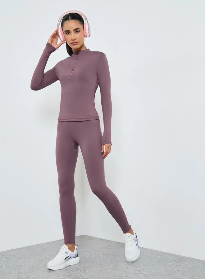 ستايلي اكتيف مجموعة من بلوزة بنصف سحاب وأكمام بفتحة إبهام وتفاصيل شبكية مع ليقنز