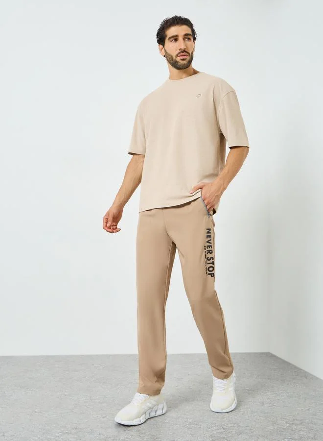 Styli Active Men Beige Graphic Training Track Pants