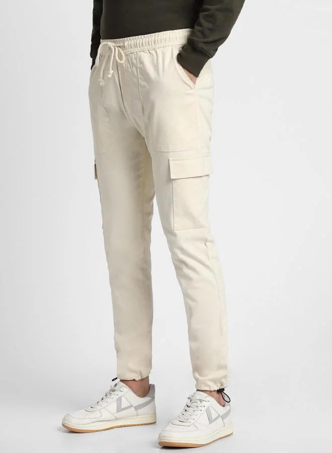 Dennis Lingo Slim Fit Cream Men's Cotton Lycra Solid Cargo Trouser, Mid Rise, Full Length, Casual,