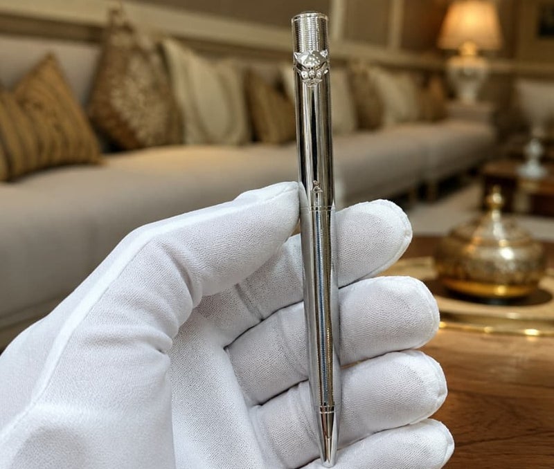 A ballpoint pen adorned with a panther (tiger) tip.