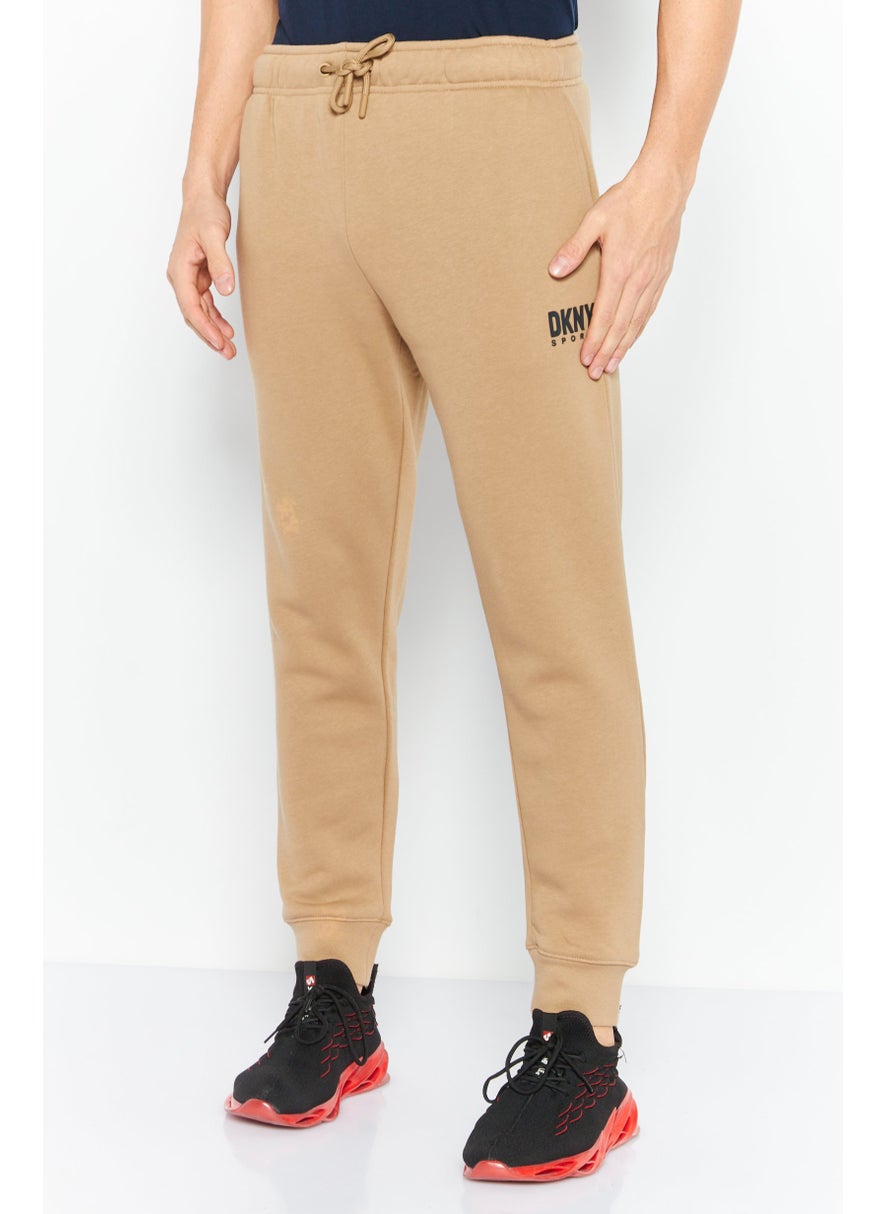 DKNY Sport Men Sportswear Fit Brand Logo Outdoor Sweatpants, Tan  - Image 1