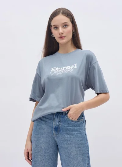 Styli Women Blue Slogan Print Short Sleeve Oversized T-Shirt