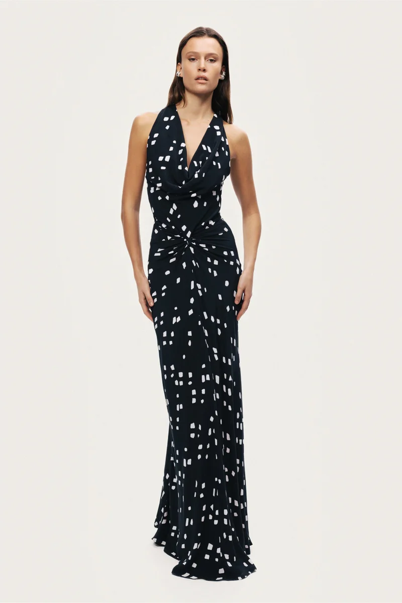 نوكتورن A fluid halter-neck maxi dress featuring an all-over abstract print and soft draping that flatters the silhouette. Designed to move effortlessly with the body, making it ideal for evening events or summer occasions.– True to size– Halter neckline with open back– Soft draped detailing at the front– Lightweight, fluid fabric with all-over print– Model is 5'11" (180 cm) tall with a 32.5" bust, 24.5" waist, and 36" hips, wearing a size S