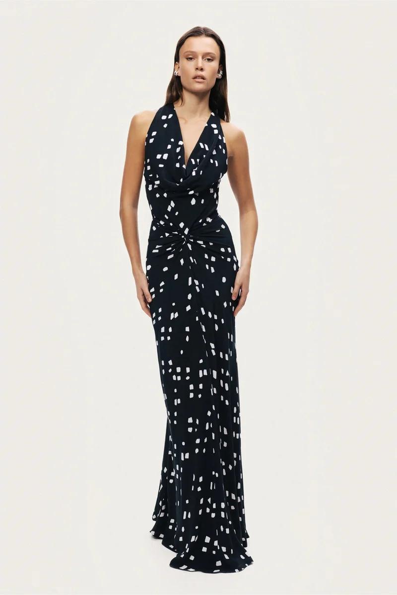 نوكتورن A fluid halter-neck maxi dress featuring an all-over abstract print and soft draping that flatters the silhouette. Designed to move effortlessly with the body, making it ideal for evening events or summer occasions.– True to size– Halter neckline with open back– Soft draped detailing at the front– Lightweight, fluid fabric with all-over print– Model is 5'11" (180 cm) tall with a 32.5" bust, 24.5" waist, and 36" hips, wearing a size S