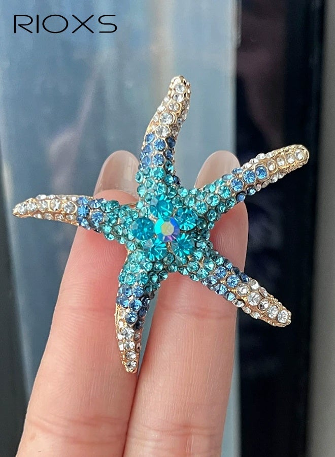 RIOXS Rhinestone Starfish Brooch Pin for Women, Gold Plated Shining Crystal Shell Star Shaped Ocean Sea Animal Brooches Lapel Pins, Delicate Wedding Beach Party Dress Accessories, Jewelry Gifts for Ladies Girls Beach Party,Blue - Image 1