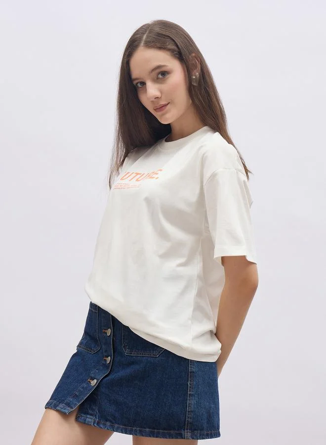 Styli Women Cream Slogan Print Short Sleeve Oversized T-Shirt