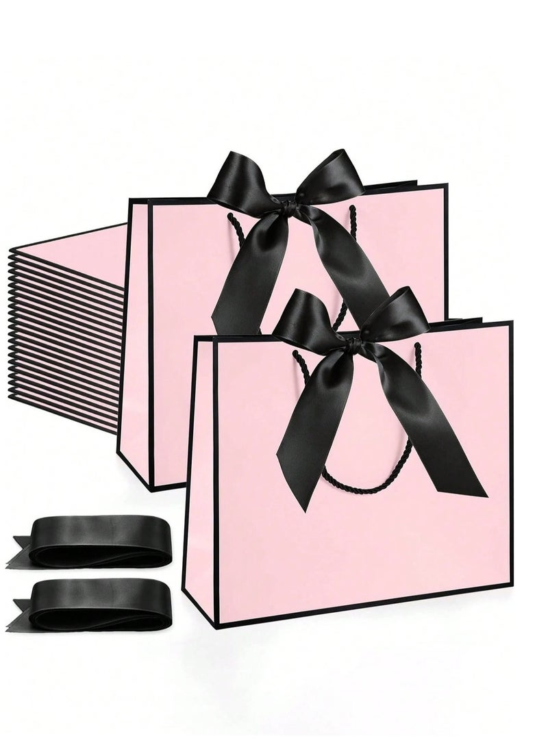 2 Kraft paper gift bags with black twisted rope handles and a black silk satin ribbon to close the bag. Perfect for presenting meaningful gifts for weddings and bachelorette parties. - Image 1