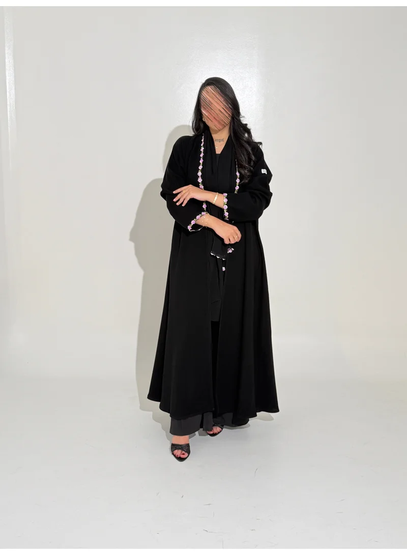 Tori-abaya Ceramic-fabric abaya with purple floral detailing.