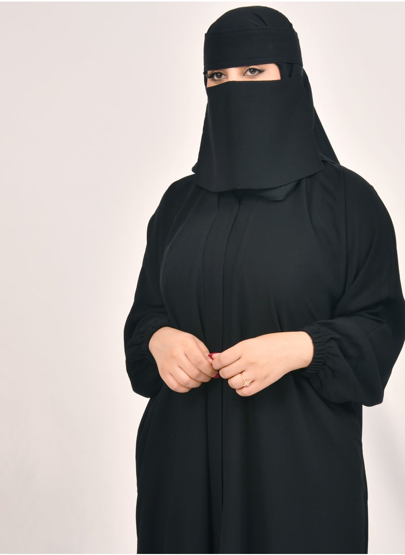 HAWRAA ABAYA - Plain black abaya with snap closure, ruffled sleeves and hidden pockets - Image 1