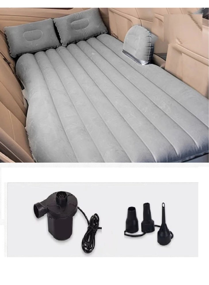 An inflatable air mattress designed for use in the car, specifically in the back seat, with pillows and an air pump for easy inflation and deflation. - Image 1