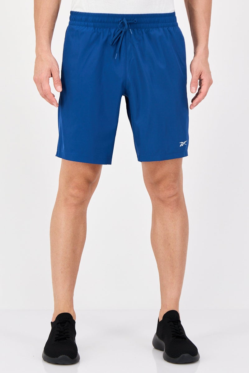 Reebok شورتات تدريب رياضية للرجال بشعار العلامة التجارية، أزرق رياضي - Image 1
