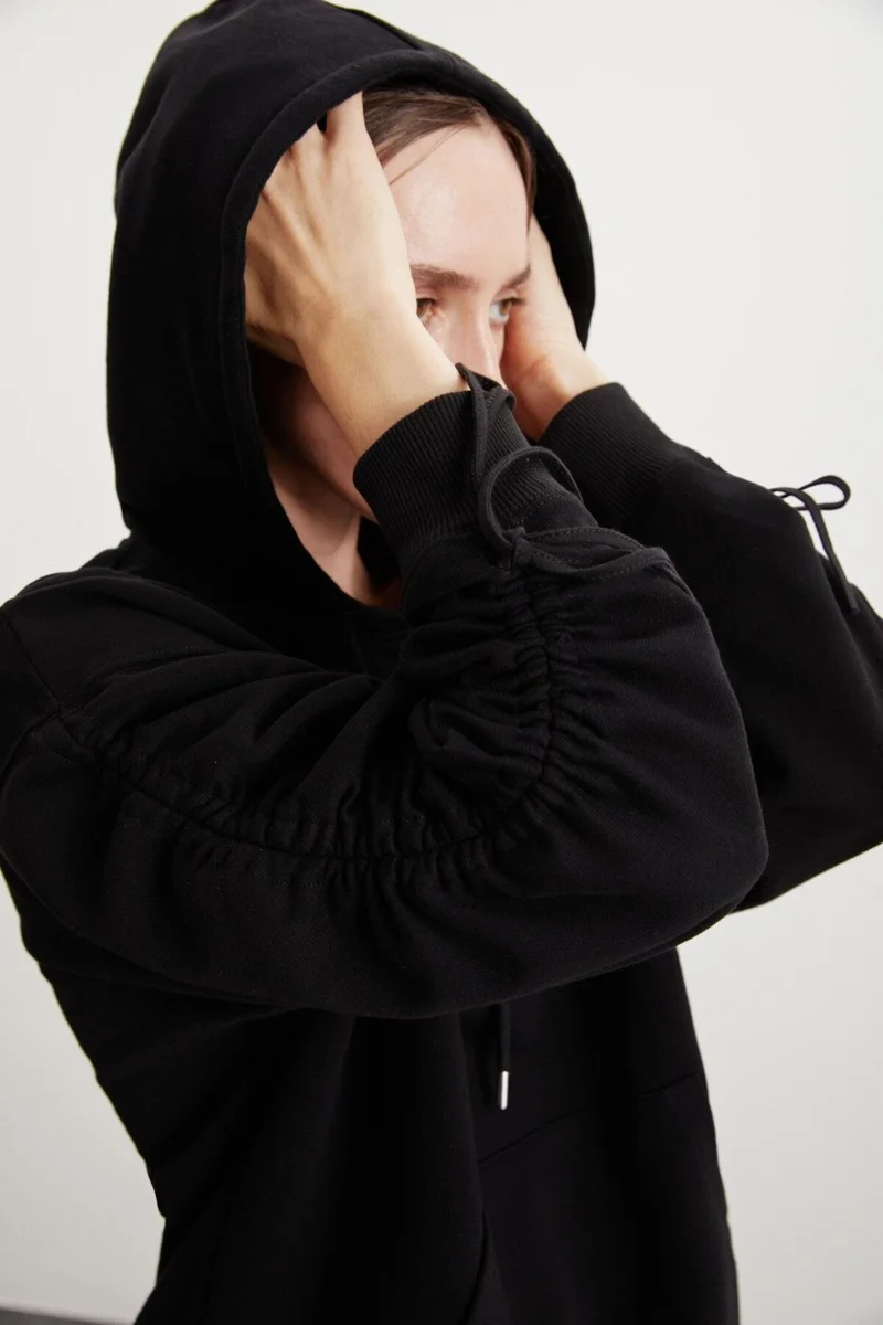 GRIMELANGE Meara Women's Hooded Sleeve Tie Detail Kangaroo Pocket Needle Detail Black Sweatshirt
