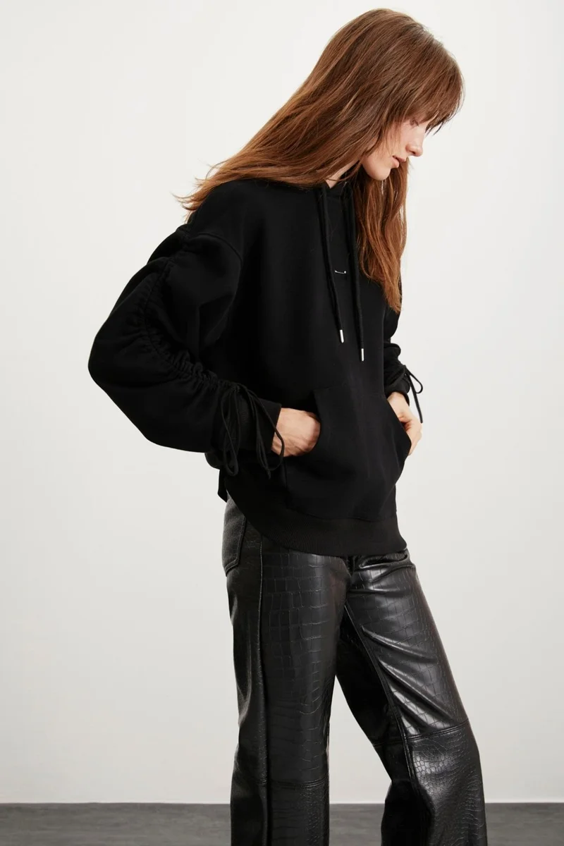 GRIMELANGE Meara Women's Hooded Sleeve Tie Detail Kangaroo Pocket Needle Detail Black Sweatshirt
