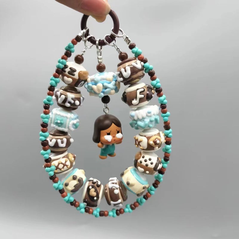 Bubble Mart Moe Grain Hug Series Mobile Phone Short Chain Hug Cute Standing Moe Grain BABY Trendy Play Mobile Phone Chain 01 Crying baby hugging black chocolate mobile phone chain