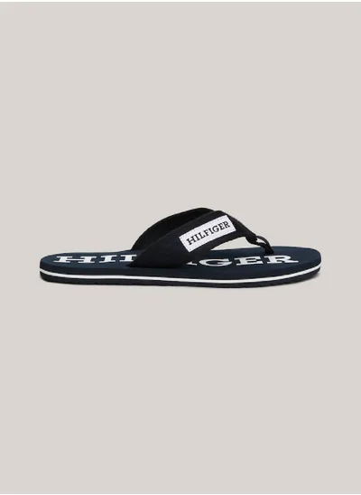 TOMMY HILFIGER Men's Hilfiger Monotype Webbing Strap Flip-Flops -  Polyester webbing upper, Blue
