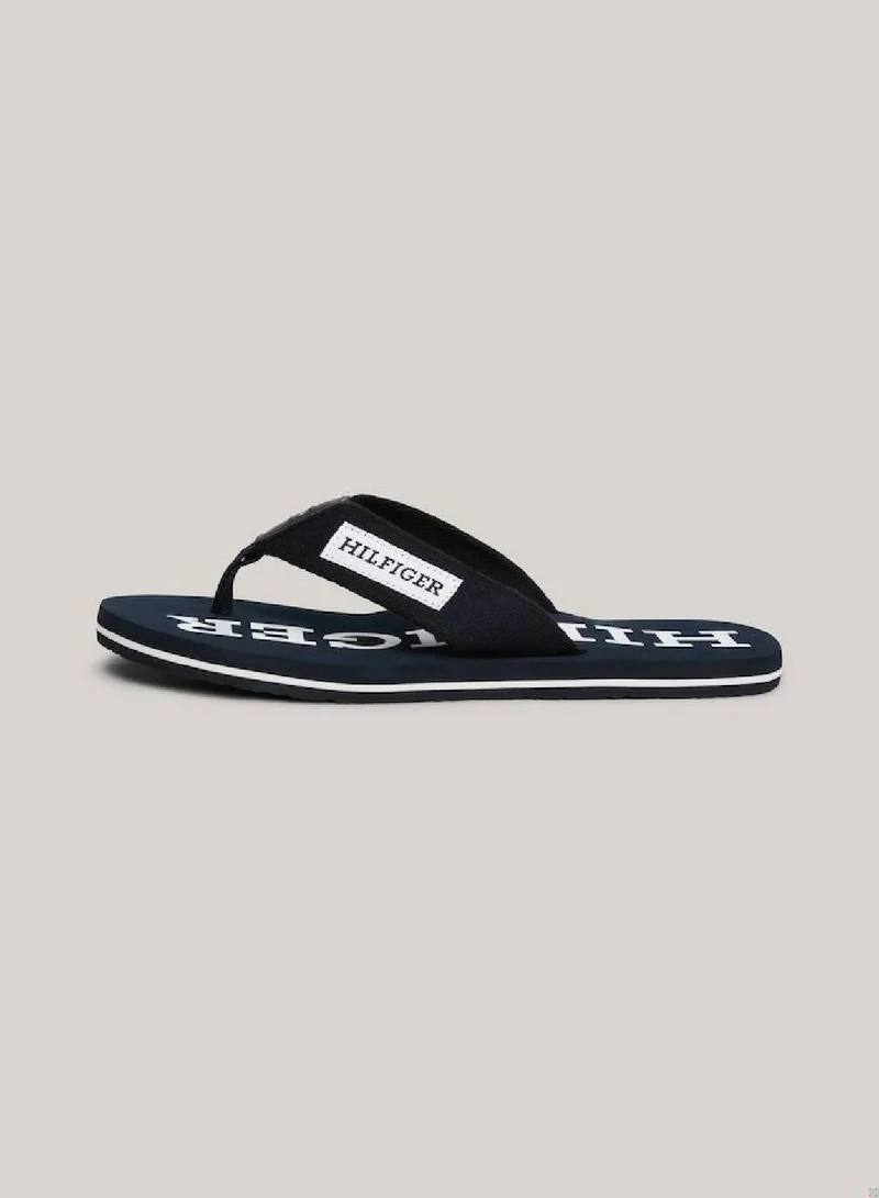 TOMMY HILFIGER Men's Hilfiger Monotype Webbing Strap Flip-Flops -  Polyester webbing upper, Blue