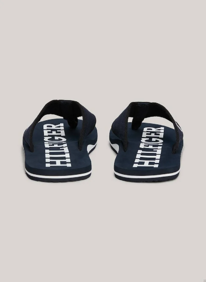 TOMMY HILFIGER Men's Hilfiger Monotype Webbing Strap Flip-Flops -  Polyester webbing upper, Blue