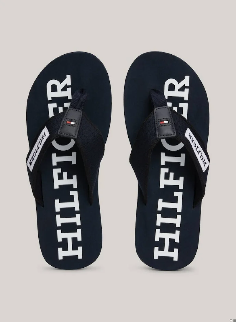 TOMMY HILFIGER Men's Hilfiger Monotype Webbing Strap Flip-Flops -  Polyester webbing upper, Blue