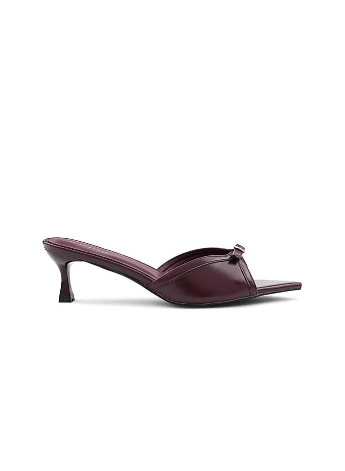 IconStyle Feminine slipper featuring a satin texture and bow.