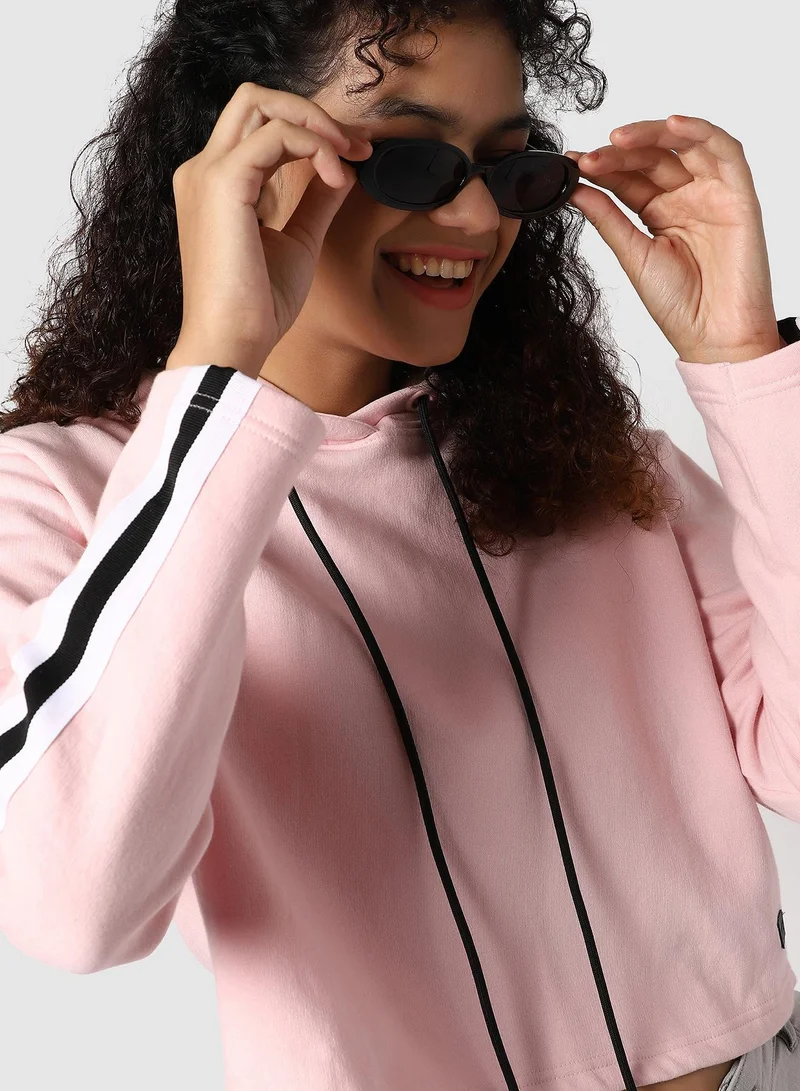 Campus Sutra Women's Pink Cropped Hoodie With Contrast Striped Sleeve For Casual Wear | Hood Neck | Long Sleeve | Drawstring Closure | Cotton Sweatshirt Crafted With Comfort Fit For Everyday Wear