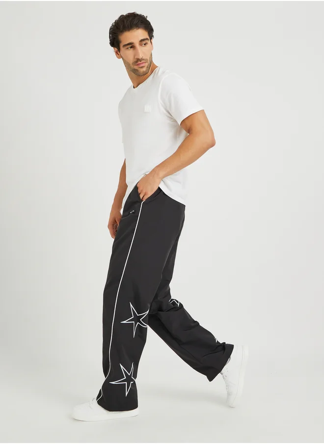 ستايلي Styli Star Printed Oversized Open Hem Joggers with Piping Detail