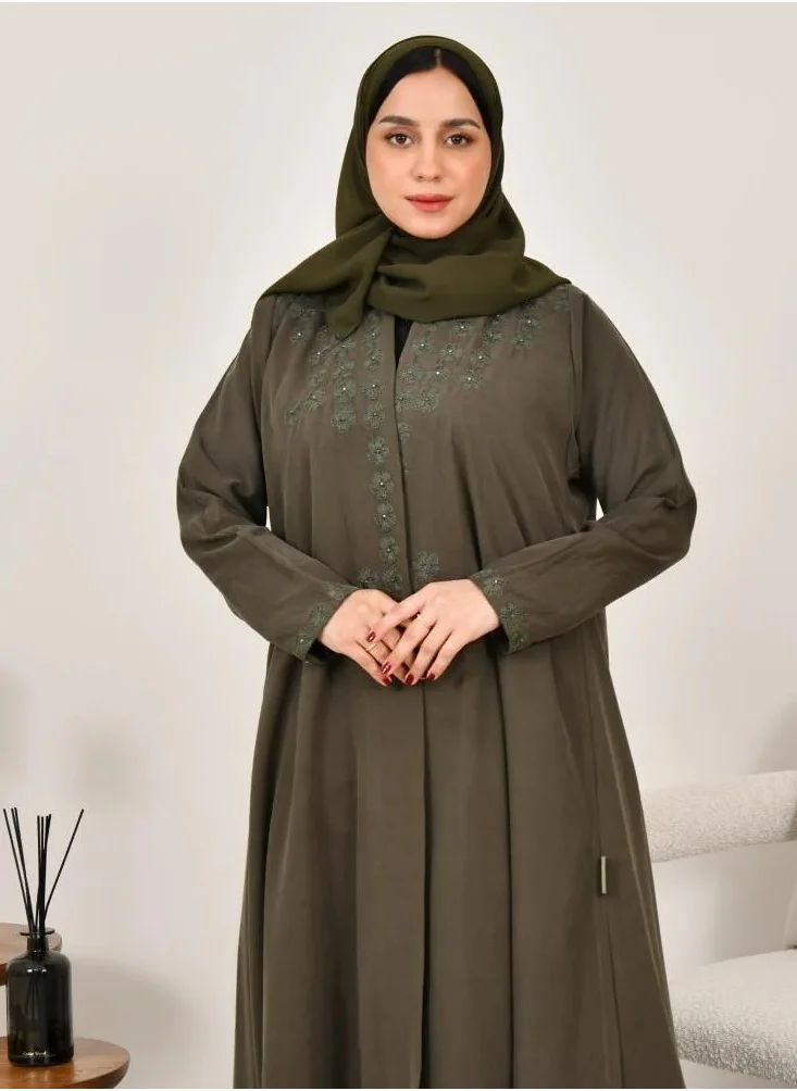 lamha abaya Elegant quarter-cloche abaya in olive green with prominent embroidery on the sides of the abaya and sleeves