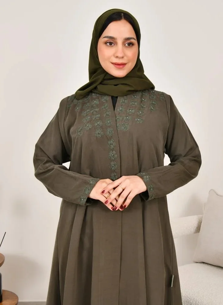 lamha abaya Elegant quarter-cloche abaya in olive green with prominent embroidery on the sides of the abaya and sleeves
