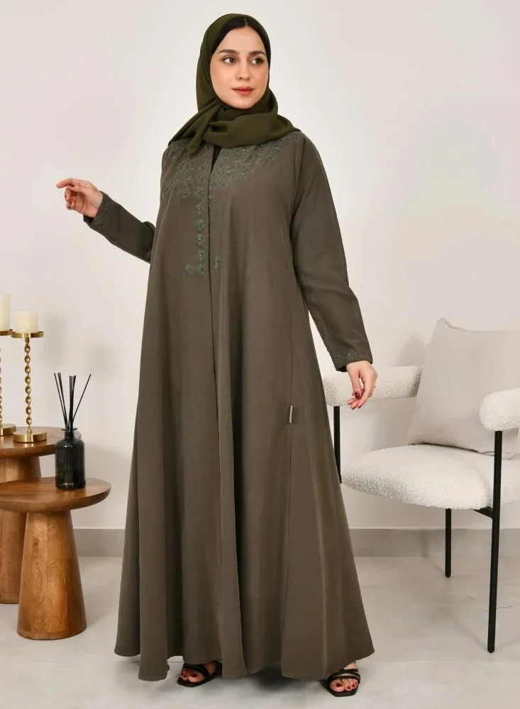 lamha abaya Elegant quarter-cloche abaya in olive green with prominent embroidery on the sides of the abaya and sleeves