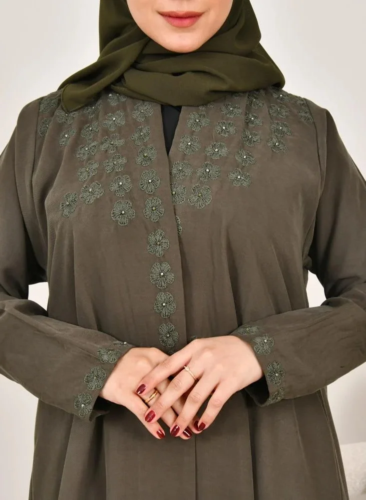 lamha abaya Elegant quarter-cloche abaya in olive green with prominent embroidery on the sides of the abaya and sleeves