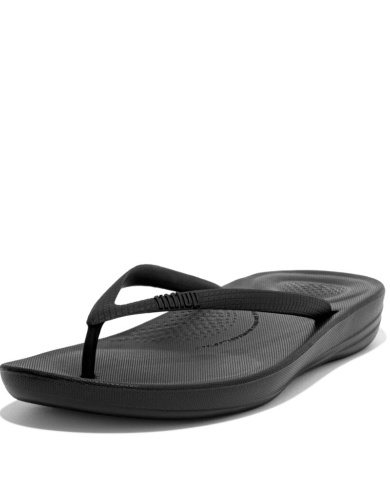 FitFlop Women's iQushion Rubber Flip-Flips with Contoured Footbed for Walking, Lightweight Ergonomic Flip Flop Sandals with Arch Support and Foot Impact Pillows, All Black, 9 US Women - Image 1