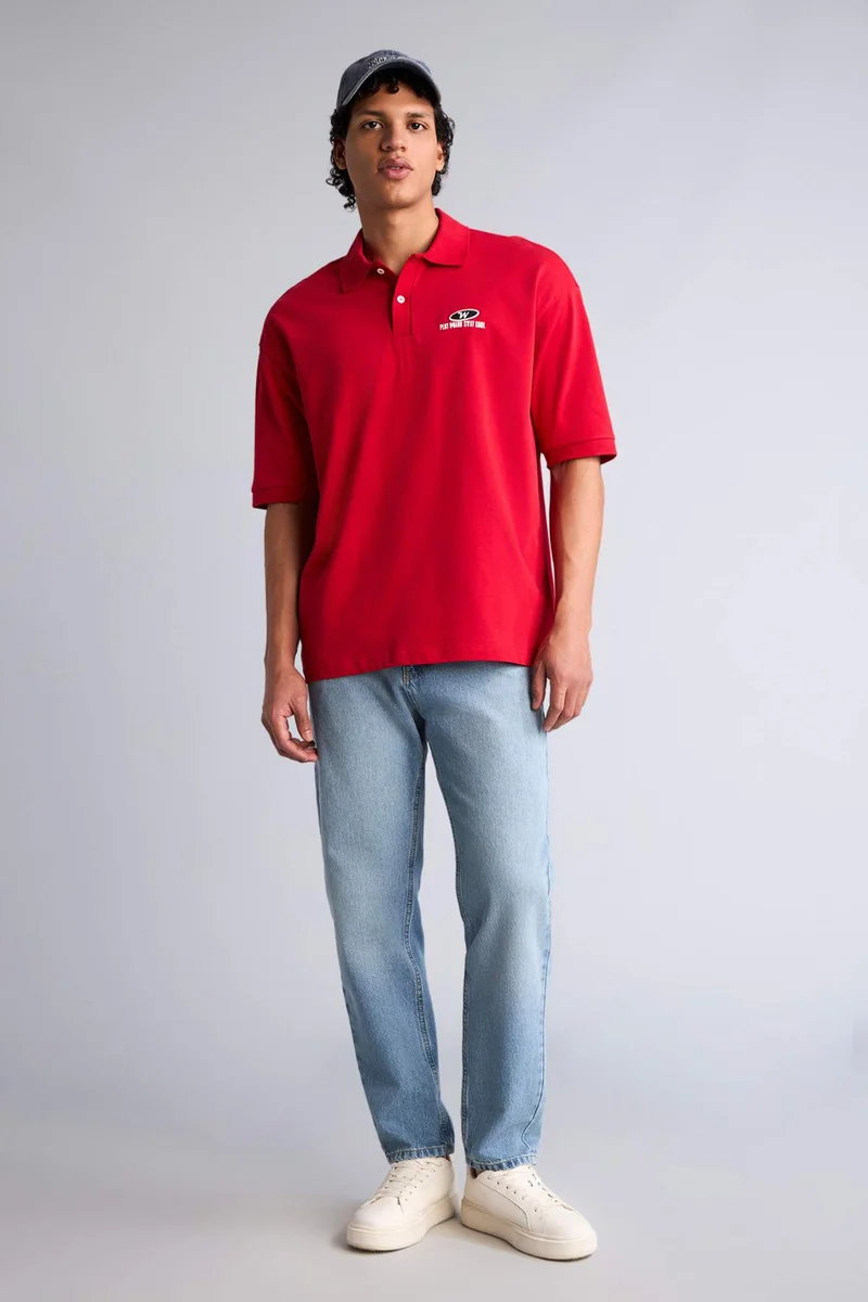 ديفاكتو Loose Fit Polo Collar Slogan Short Sleeve Polo T-Shirt
