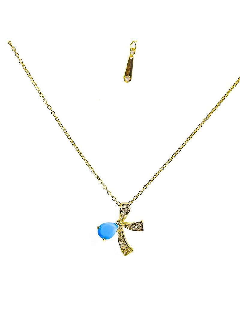 FLUFFY A golden necklace with a captivating bow design, featuring a vibrant oval-shaped gemstone at its center  - Image 1