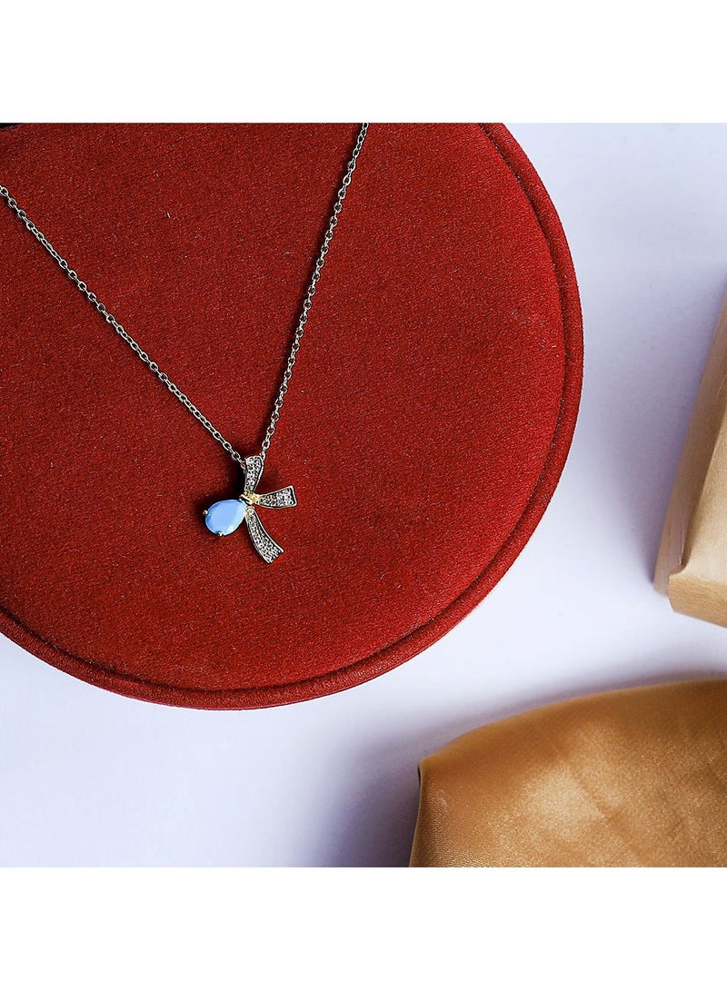 FLUFFY A golden necklace with a captivating bow design, featuring a vibrant oval-shaped gemstone at its center  - Image 2