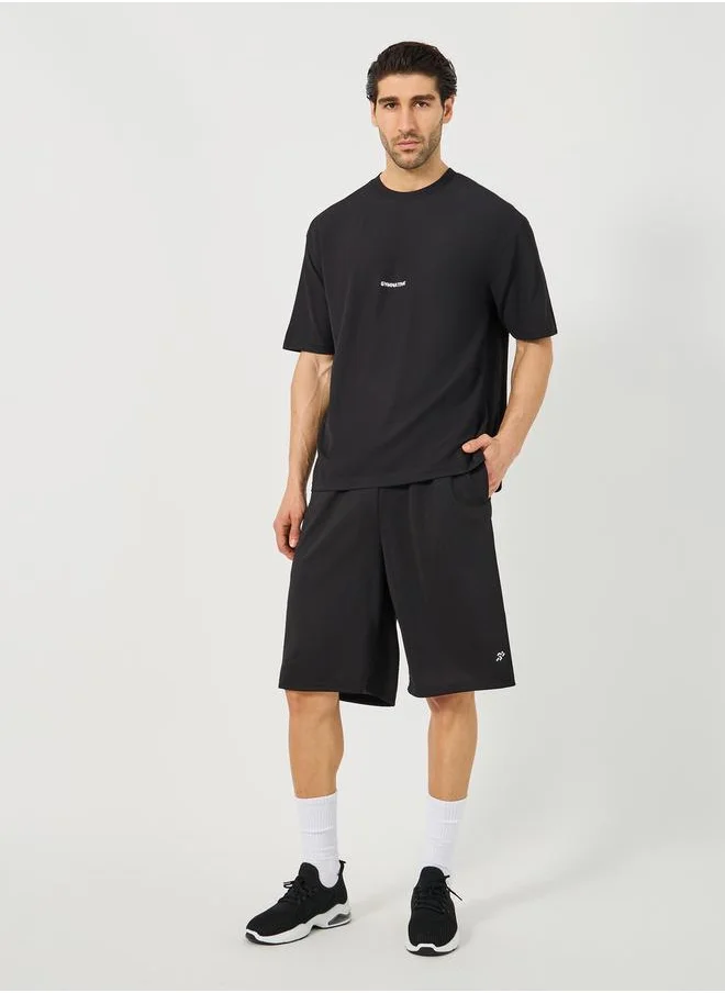 ستايلي Mesh Insert Oversized Training Shorts with Badge Detail